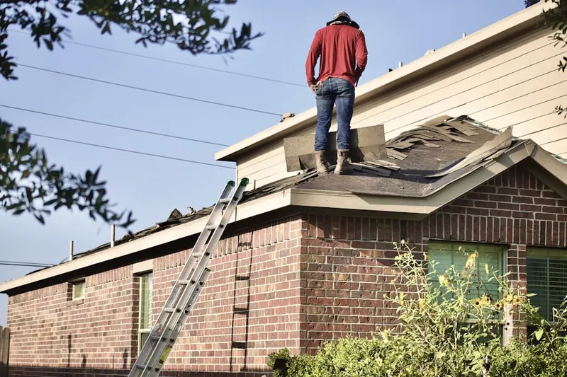 Professional roofer working on a residential roof in Paramount